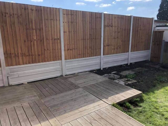 Closeboard panels and gravel boards above a decked garden